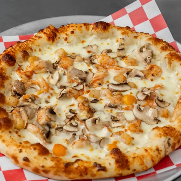 Flame and Cones Pizza with shrimp and mushrooms on a red and white checkered paper.