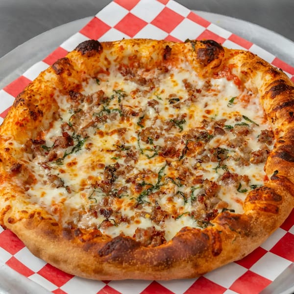 Flame and Cones Pizza's Italian sausage and basil pizza, with melted cheese and a golden crust.